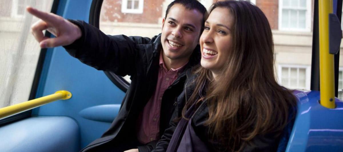Young couple on a charter or shuttle bus, customer of a charter bus