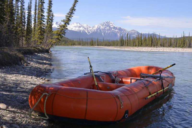 orange raft on river bank