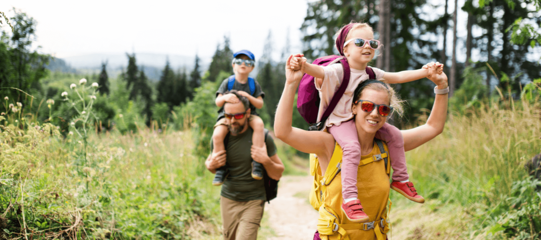 happy family of four on a hike