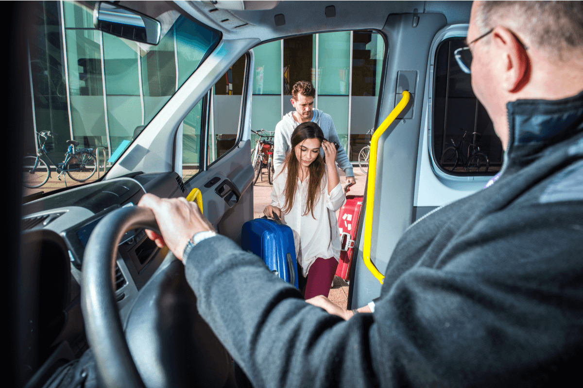 Shuttle bus driver opening the door for passengers. 