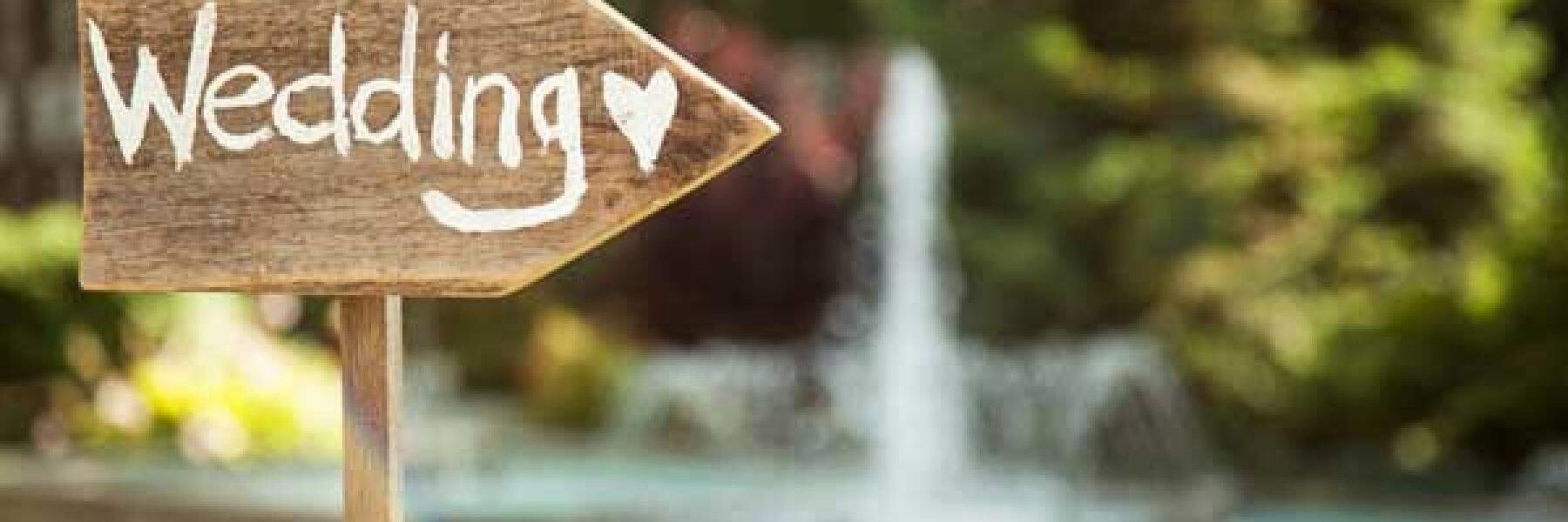 wood arrow sign reading Wedding