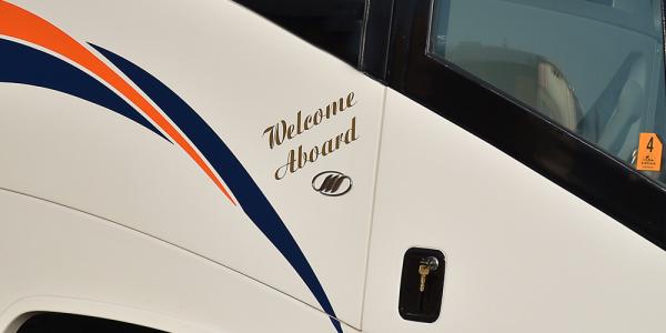Motorcoach door saying Welcome aboard