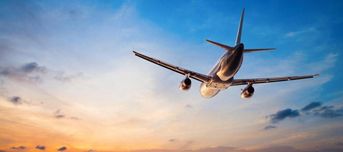 photograph from below an airplane, airplane taking off from runway