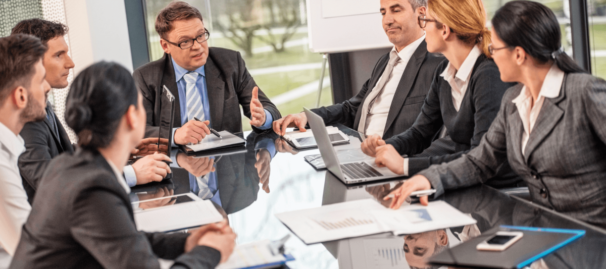 Corporate Business Meeting, team gathered around a table