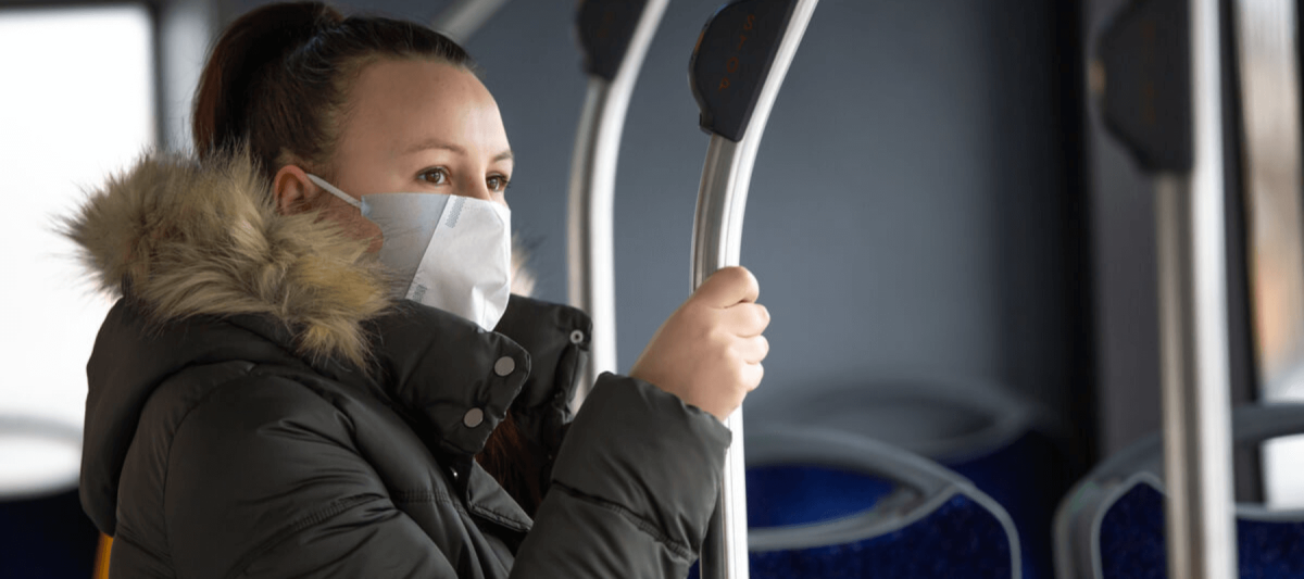woman wearing mask on bus