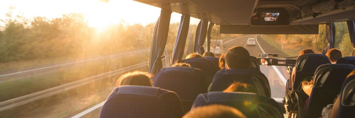 charter bus interior facing the road with sunset