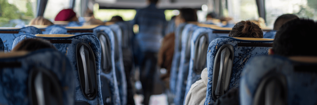 employees riding to company event in a charter bus