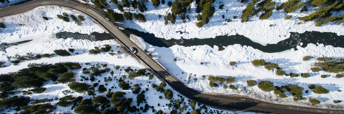 Birds eye view of a car traveling down a winding Idaho road