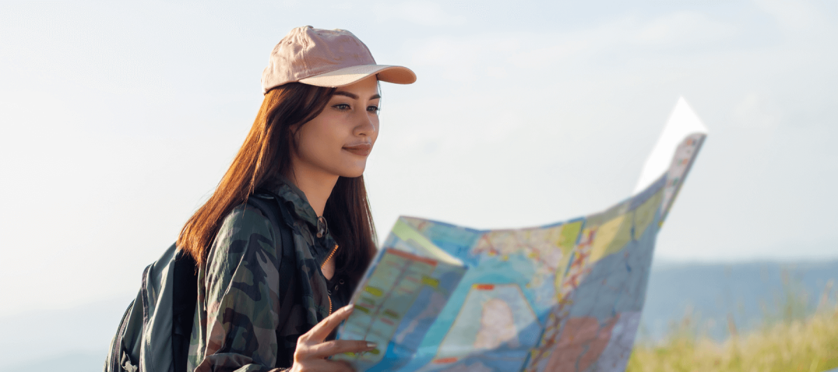 woman looking at map outside